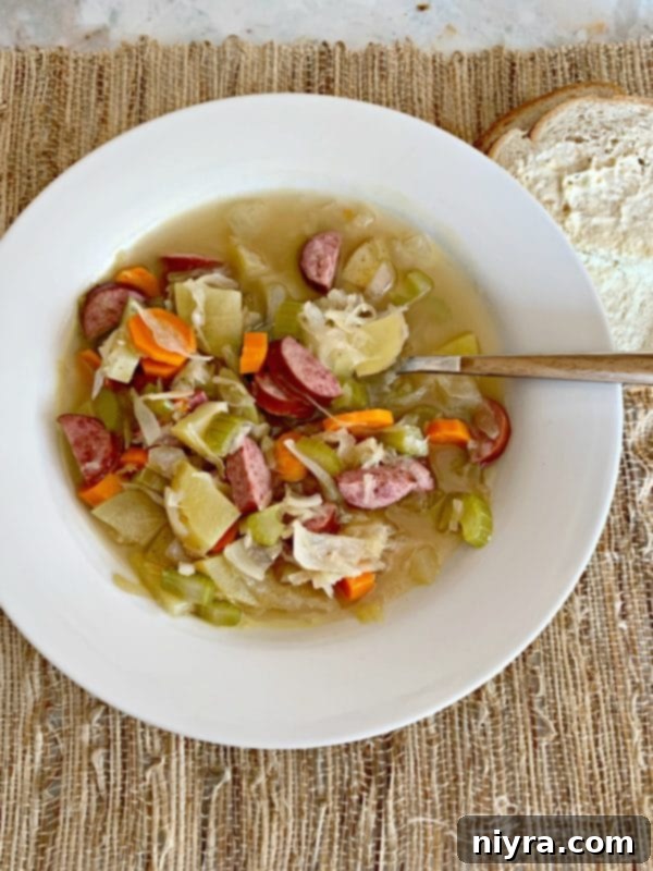 Overhead shot of Polish Sauerkraut Soup - Kapusniak in a white bowl, ready to be served