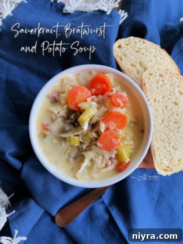 A beautifully presented bowl of Polish sauerkraut soup with an artisanal bread slice on a rustic table