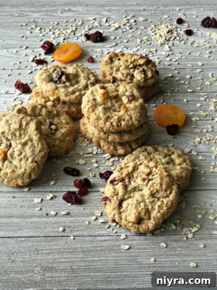 Delicious Cranberry Apricot Oatmeal Cookies stacked on a wooden board