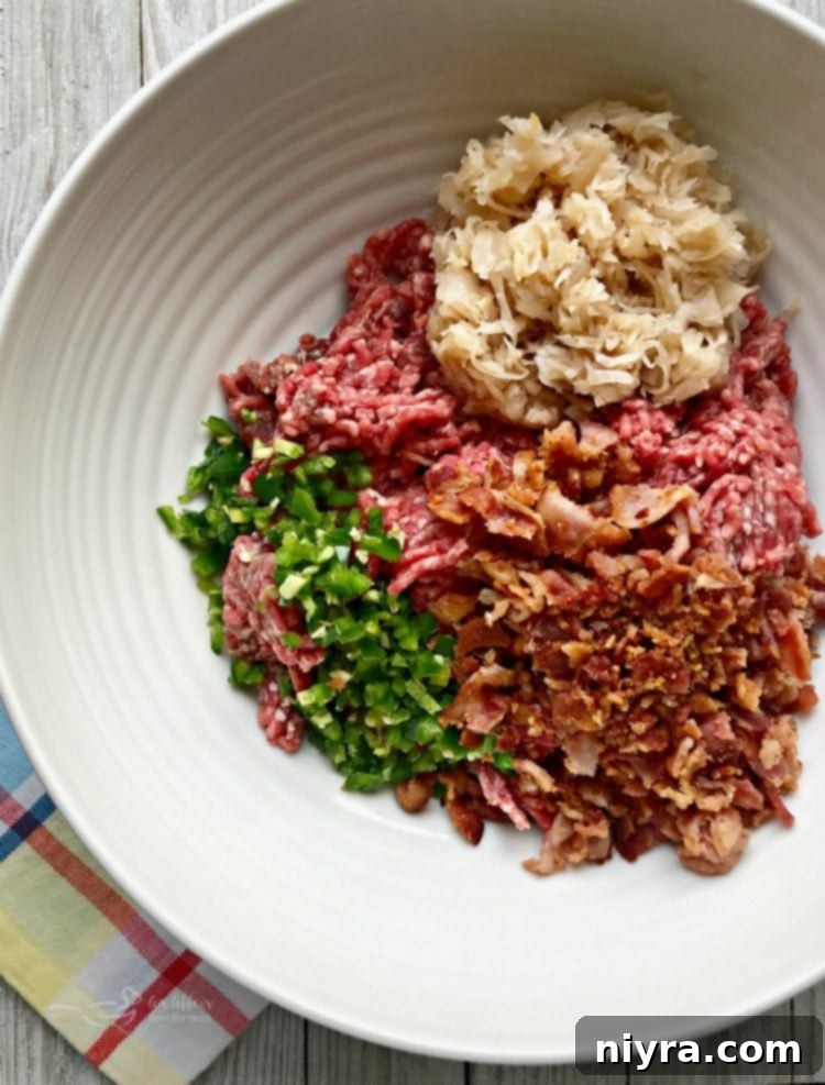 Krautfire Bacon Burger 4 Ingredients for Spicy Bacon Kraut Burger laid out: ground beef, jalapeños, sauerkraut, and crumbled bacon.