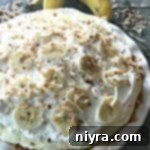 Close up of Banana Cream Pie in a white dish, garnished