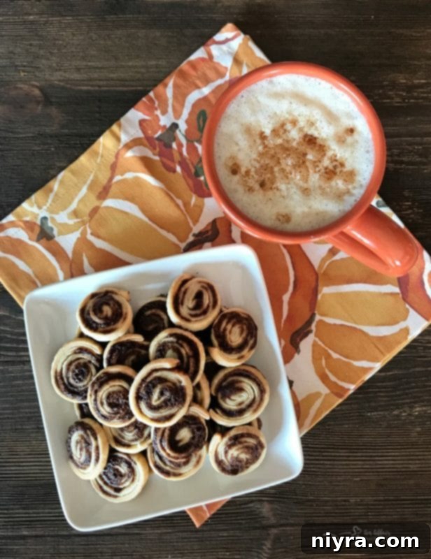 Close-up of golden brown Pumpkin Spice Swirls on a white plate, made from leftover pie crust