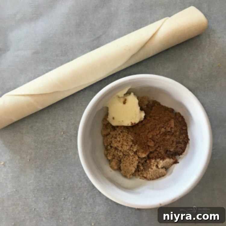 Step-by-step image of combining butter, brown sugar, and pumpkin pie spice in a bowl