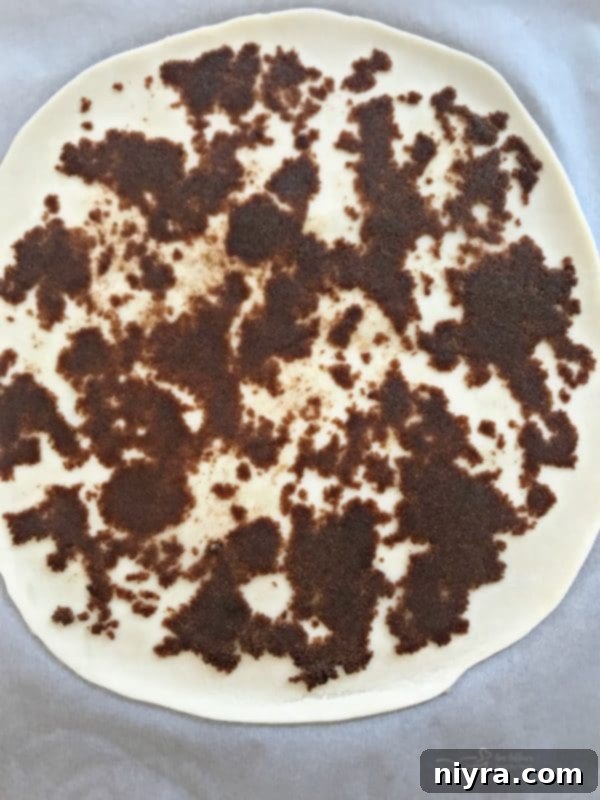 Image demonstrating how to spread the pumpkin spice mixture evenly over the pie crust