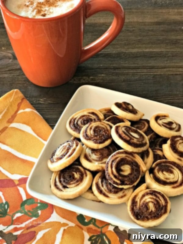 Plate of delightful Pumpkin Spice Swirls alongside a steaming hot cup, perfect for a fall treat