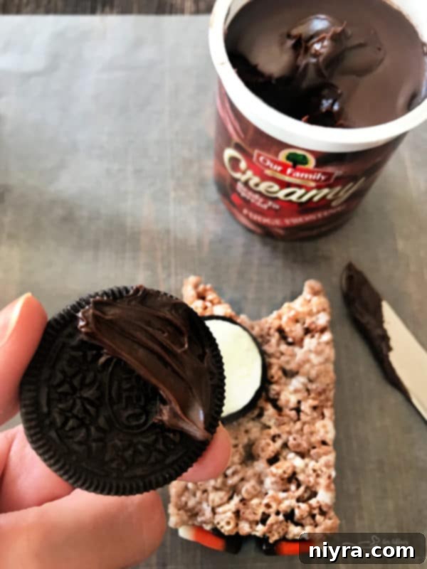 Decorating Cocoa Krispy Owls with candy and frosting