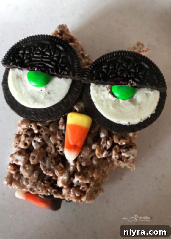 Child taking a bite out of a Cocoa Krispy Owl treat