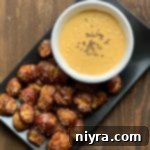 Tangy Kraut Cheddar Pretzel Bites 18 Overhead of Quick Pretzel Bites with Sauerkraut Cheddar Cheese Sauce dip plated