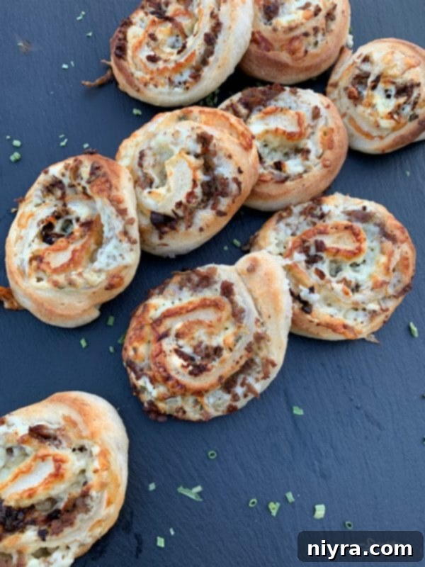 Steak and Kraut Pinwheels with Caramelized Onions and White Cheddar 9 Beautifully arranged Steak & Kraut Pinwheels with caramelized onions and white cheddar cheese, garnished with chives