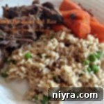 Roast, rice and carrots on a white plate