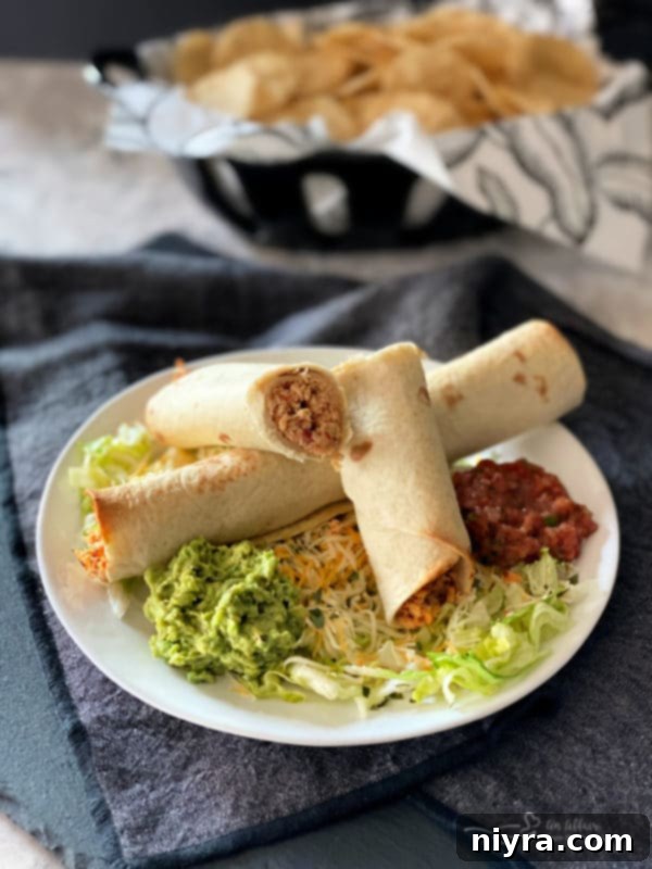 Close-up of golden-brown Baked Chicken Taquitos, perfectly crispy, ready to be enjoyed as a healthy comfort meal.
