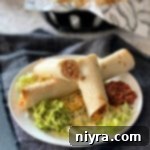 Side view of Baked Chicken Taquitos plated