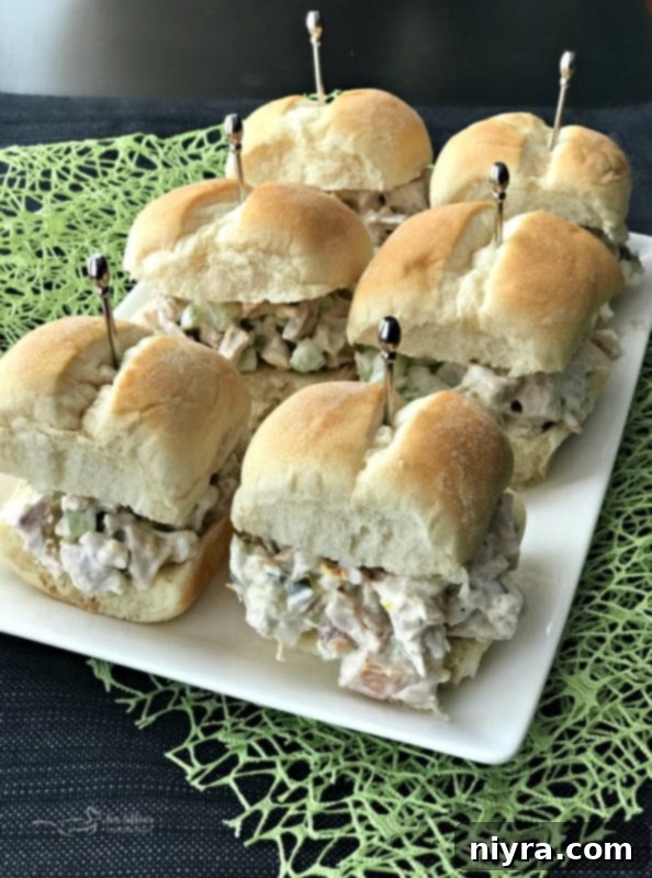 Assortment of homemade Turkey Salad Sliders on a rustic wooden board