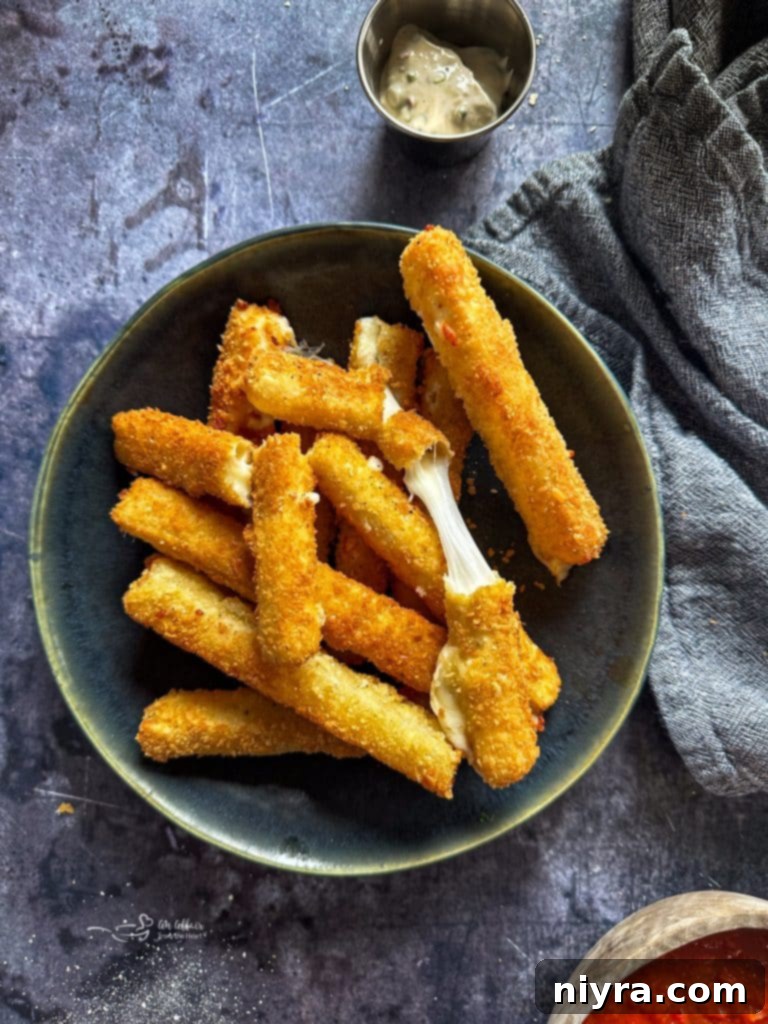 Mozzarella sticks on a green plate, indicating other air fryer snacks.