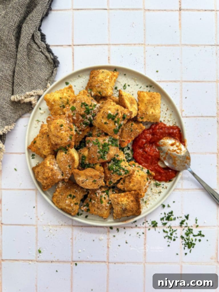 Plate of golden brown Air Fryer Toasted Ravioli with fresh parsley garnish.