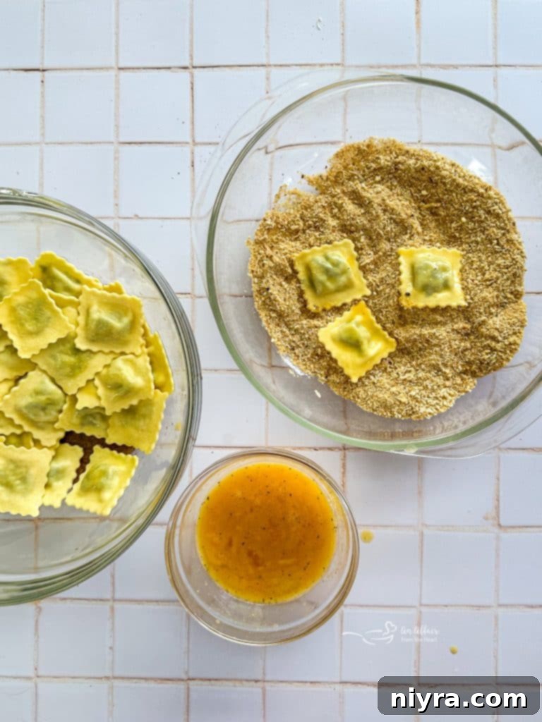 Two bowls: one with breadcrumbs and parmesan, another with beaten eggs for dipping.