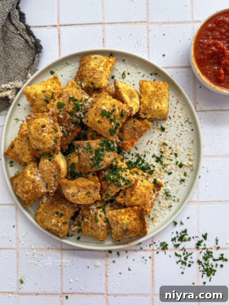 Crispy Air Fryer Toasted Ravioli in the air fryer basket.