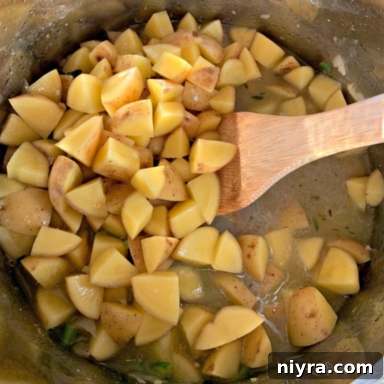 Creamy Instant Pot New England Clam Chowder 8 Potatoes and broth in an Instant Pot