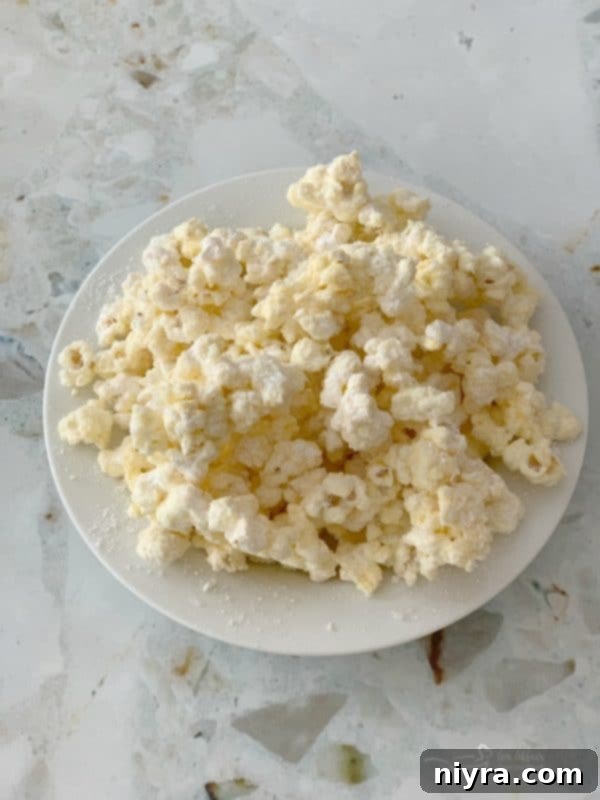 Close-up of Winter Wonderland Popcorn, coated in white chocolate and dusted with sugar crystals