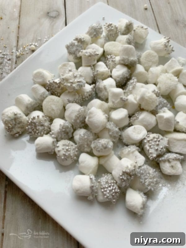 Close-up of white chocolate-dipped marshmallows adorned with various sprinkles