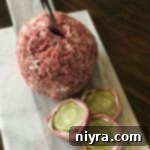 Dill Pickle Wrap Cheese Ball and slices of dill pickle wrap on a cutting board