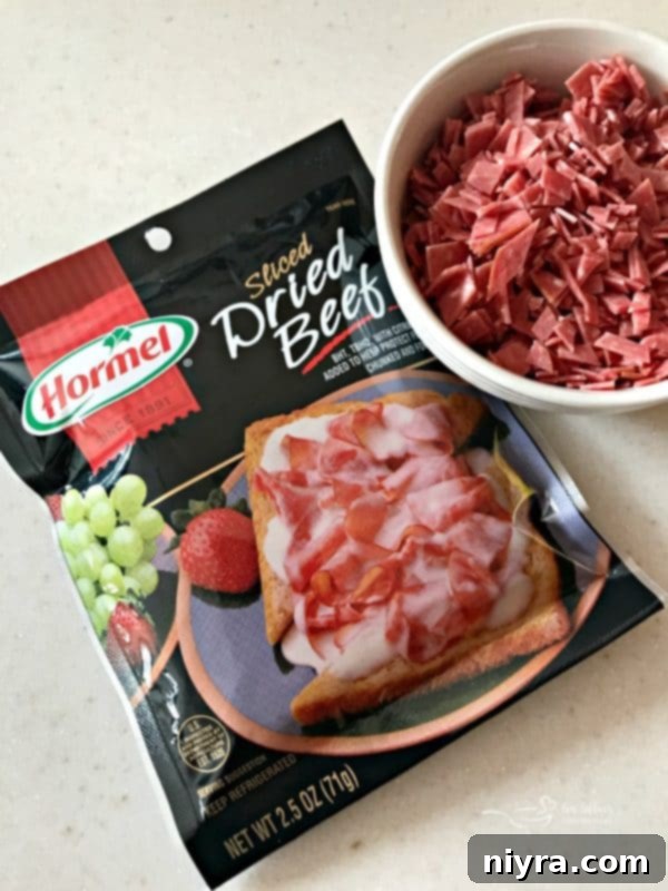 Ingredients for Dill Pickle Wrap Cheese Ball, including cream cheese, dried beef, and chopped dill pickles