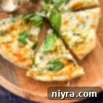 cutting and serving spinach and alfredo pizza