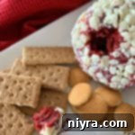 Red Velvet Cheese Ball on a white platter with cookie