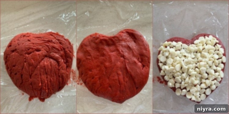 The process of shaping the Red Velvet Cheese Ball into a heart, with a portion of white chocolate chips ready for coating.