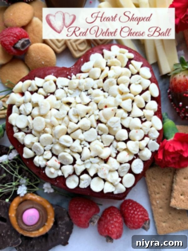 A heart-shaped Red Velvet Cheese Ball as the focal point of a dessert cheeseboard, surrounded by other sweet treats.