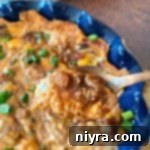 Baked Chili Cheese Bean Dip close up on a spoon