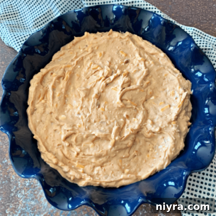 Ingredients for Chili Cheese Bean Dip laid out for prep, including canned beans, cream cheese, shredded cheese, and hot sauce
