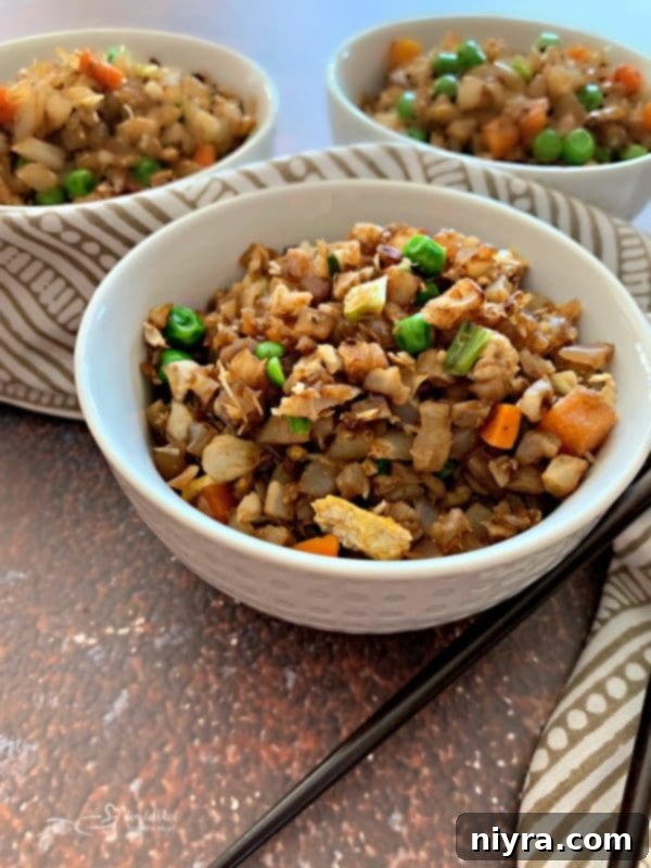 Close-up of Cauliflower Fried Rice with green onions and peas