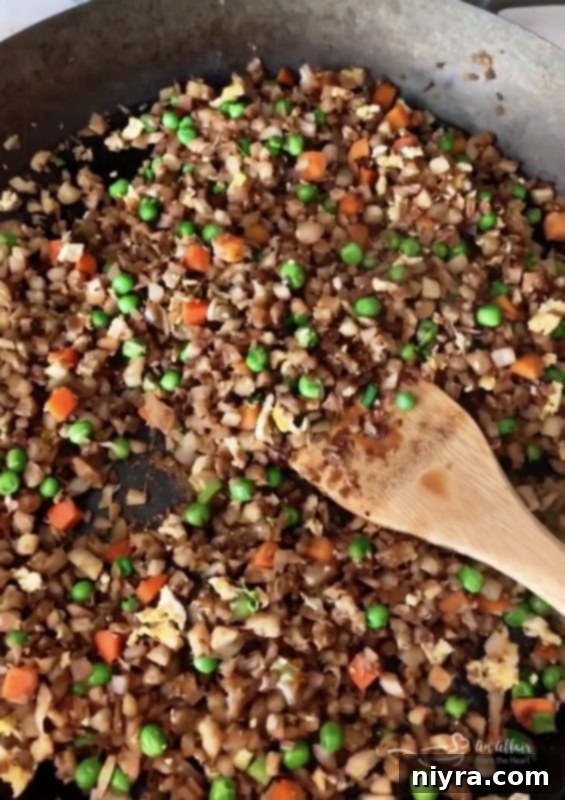 Cauliflower Fried Rice ingredients being prepped in a Lodge Cast Iron skillet
