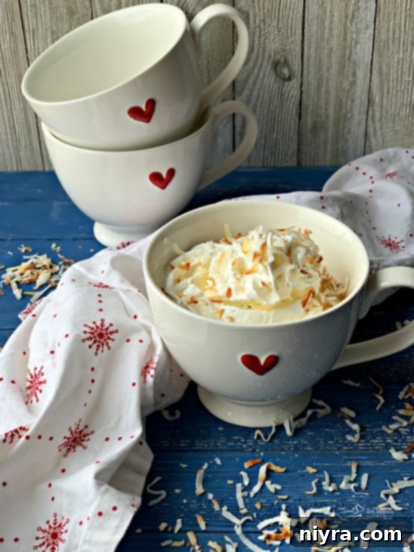 A festive Coconut Mug Cake served in a heart-themed mug for Valentine's Day