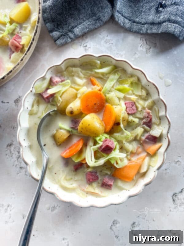 Velvety Corned Beef and Cabbage Soup 2 Creamy Corned Beef & Cabbage Soup in a white scalloped bowl