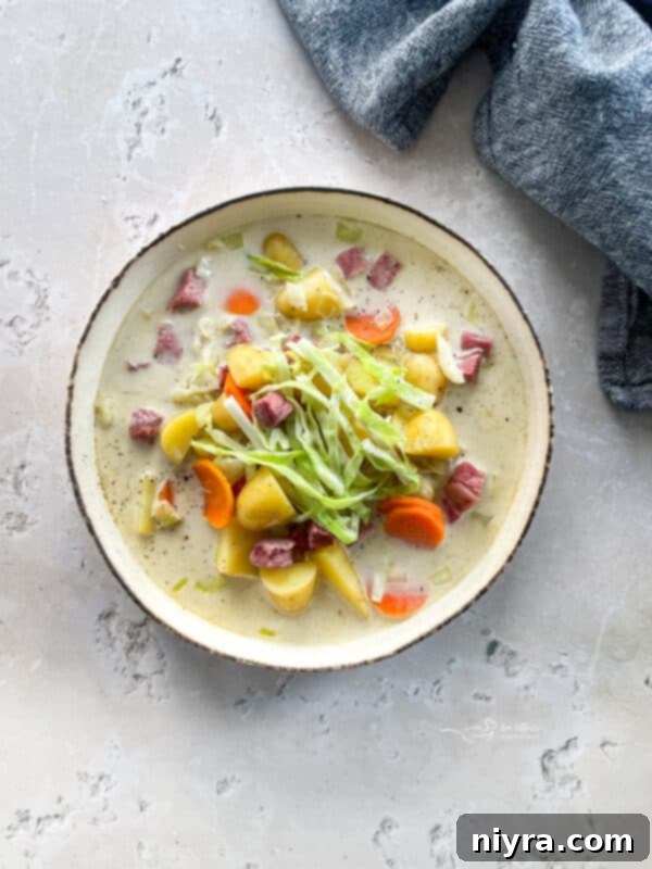 Velvety Corned Beef and Cabbage Soup 13 Creamy Corned Beef & Cabbage Soup in a white bowl