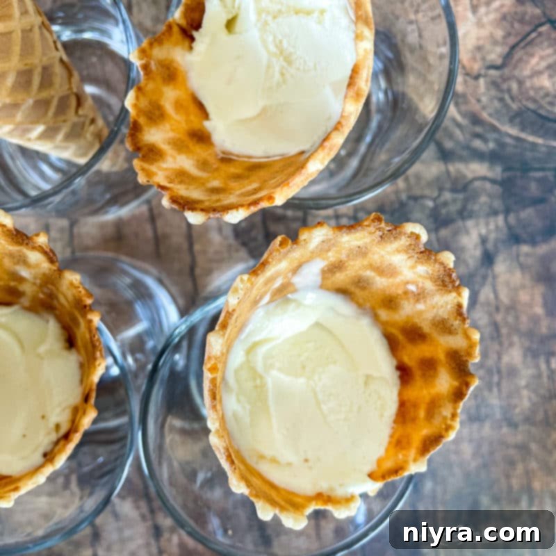 Crafted Kitchen Drumsticks 8 A top-down view of vanilla ice cream expertly packed into several sugar cones.