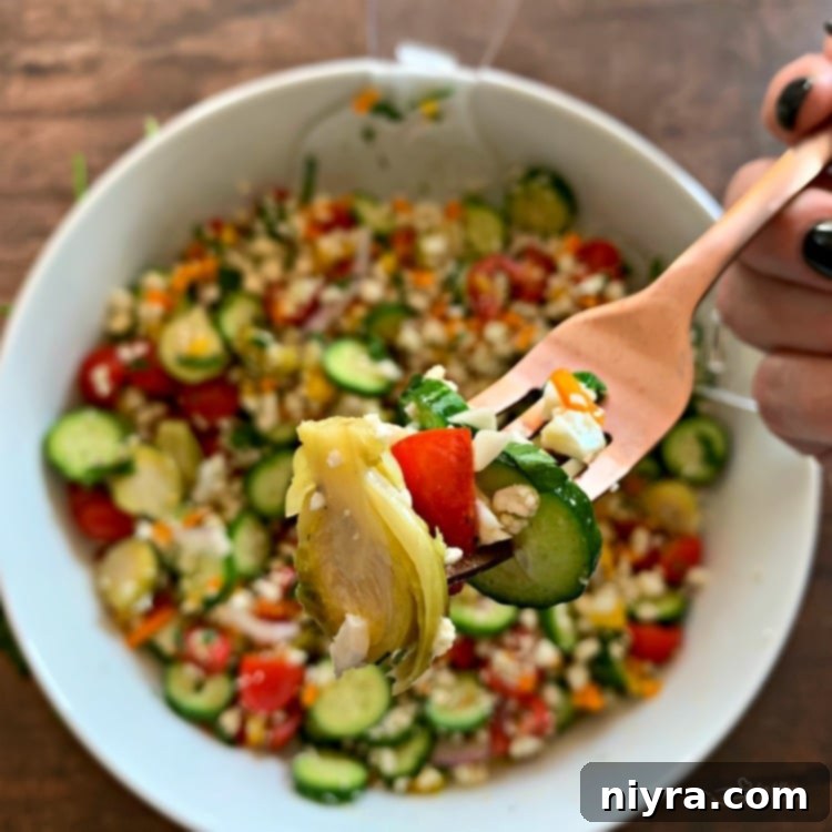Close-up of a bite of Greek Cauliflower Rice Salad with Brussels Sprouts