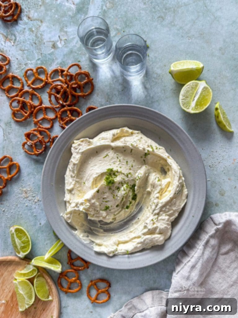 A close-up of creamy Margarita Dip, garnished with lime zest.