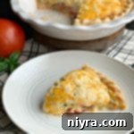 Tomato Pie in a pie dish and a slice on a white plate