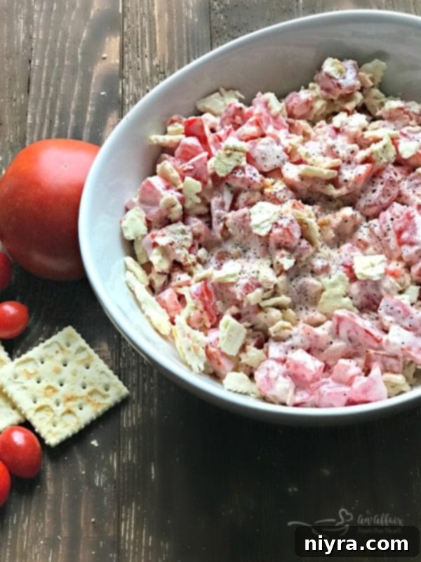 Close-up of a refreshing Tomato Cracker Salad in a white bowl, ready to be served.