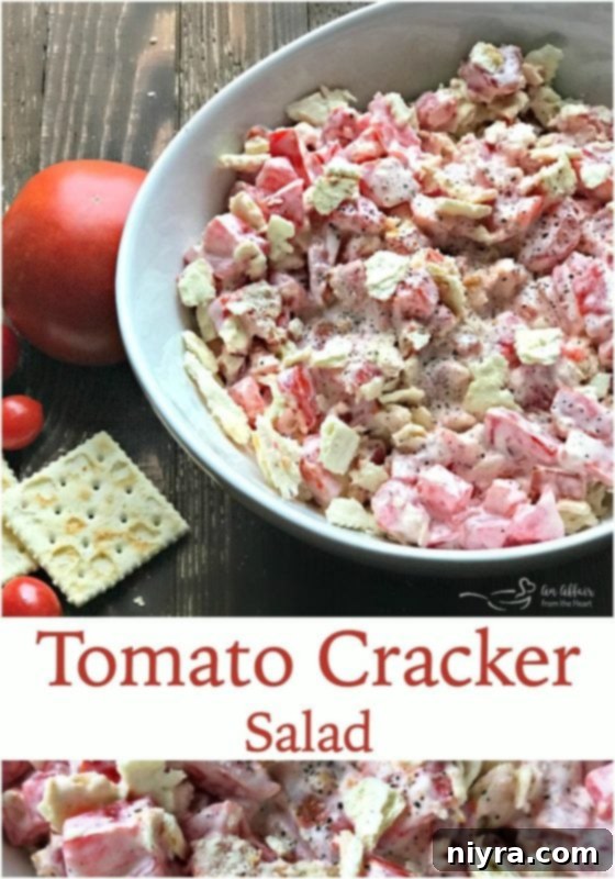 A vertical shot of Tomato Cracker Salad in a bowl, with the text 'LOVE IT? Pin It!' below.
