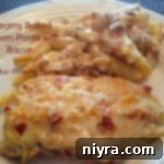 Creamy baked chicken pasta with bacon on a white plate with text "creamy baked chicken pasta with bacon"