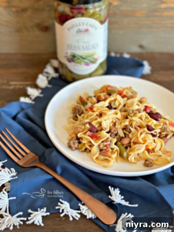 Sizzling ground beef with minced onion and seasonings in a skillet