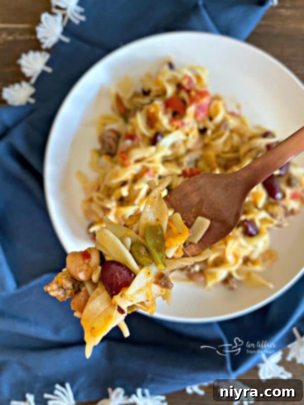 A spoonful of Five Bean Ground Beef & Noodle Skillet Casserole showing rich texture