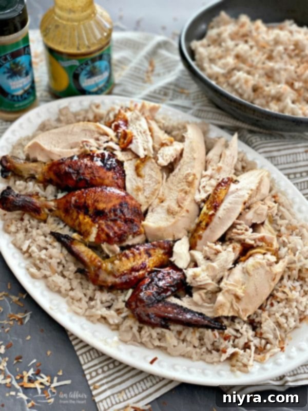Carved Jamaican Jerk Glazed Chicken over Sweet Coconut Rice on a platter
