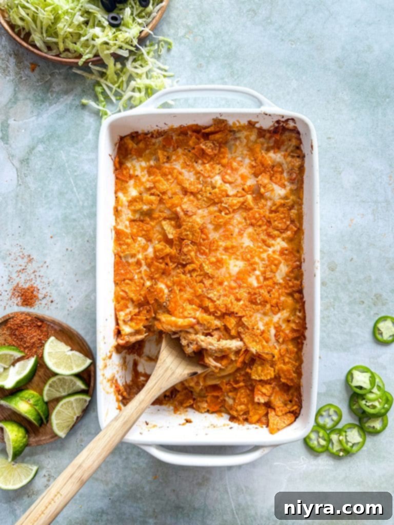Overhead view of a baking dish filled with unbaked Chicken and Doritos Casserole before oven.