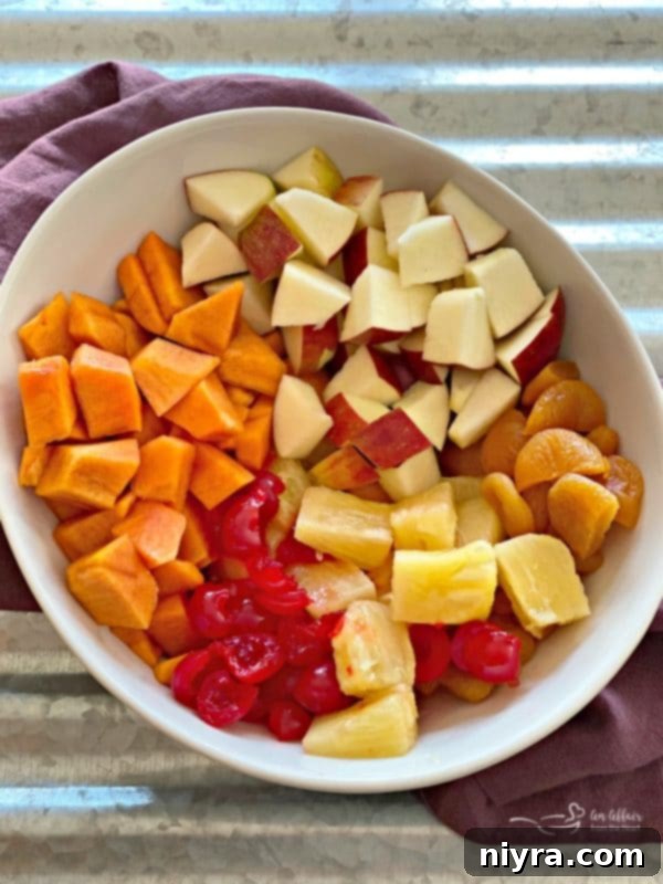 Ingredients for Persimmon Salad, including diced fruit, in a mixing bowl, ready to be combined.