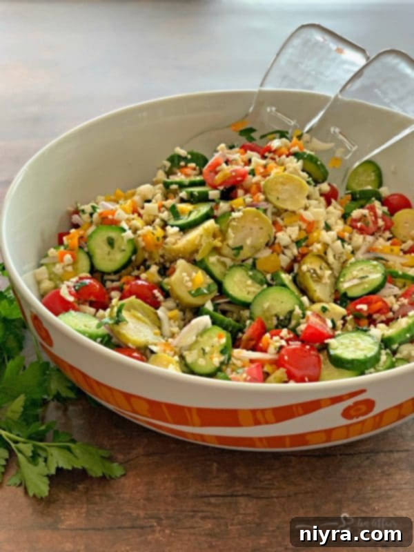 A vibrant Greek Cauliflower Rice Salad adorned with fresh vegetables and Brussels Sprouts